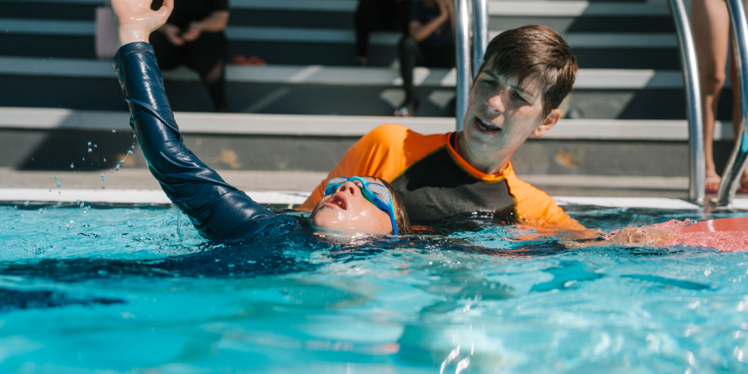 A boy is being instructed during a swimming lesson